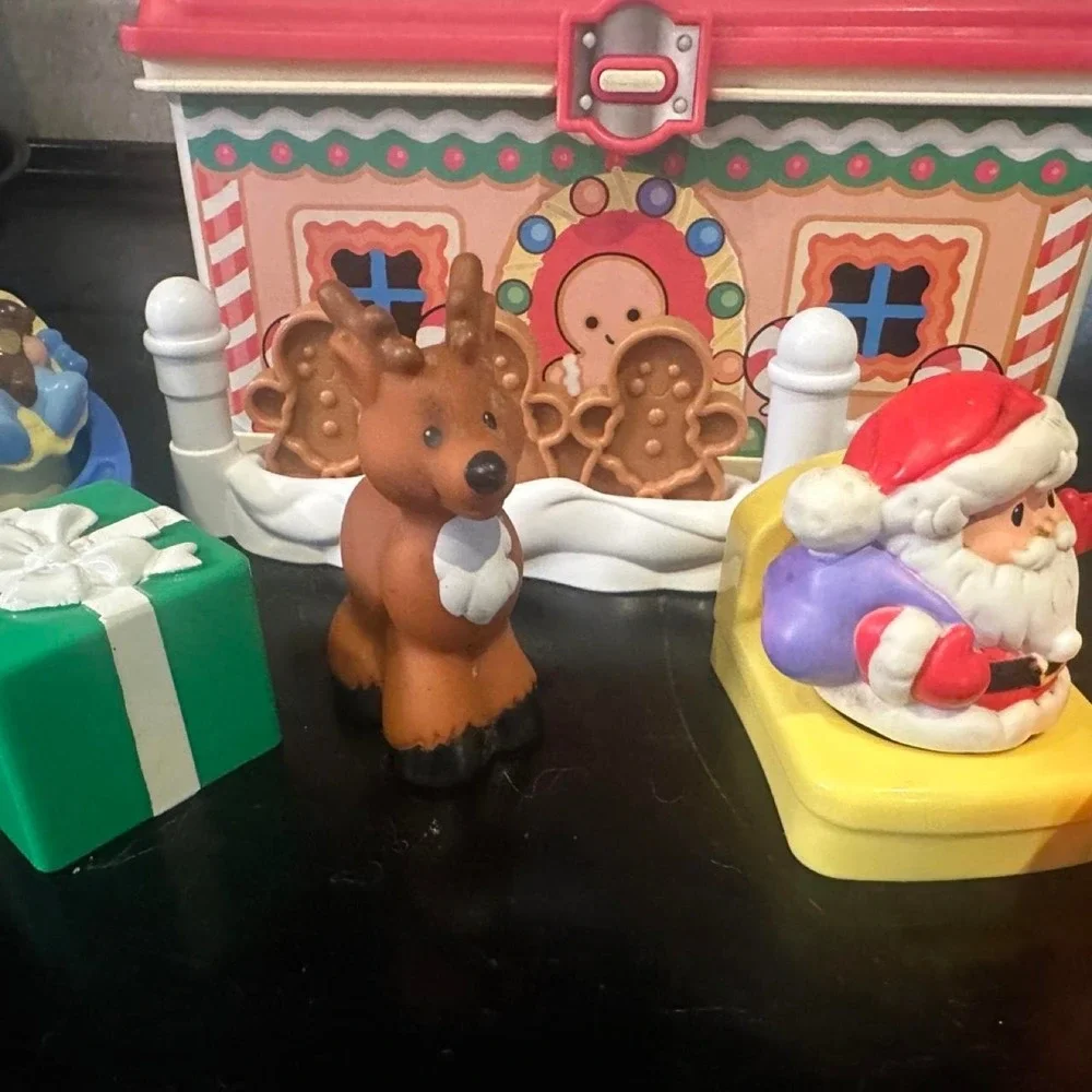 Vintage Fisher Price Christmas playset with Santa, reindeer, and gingerbread